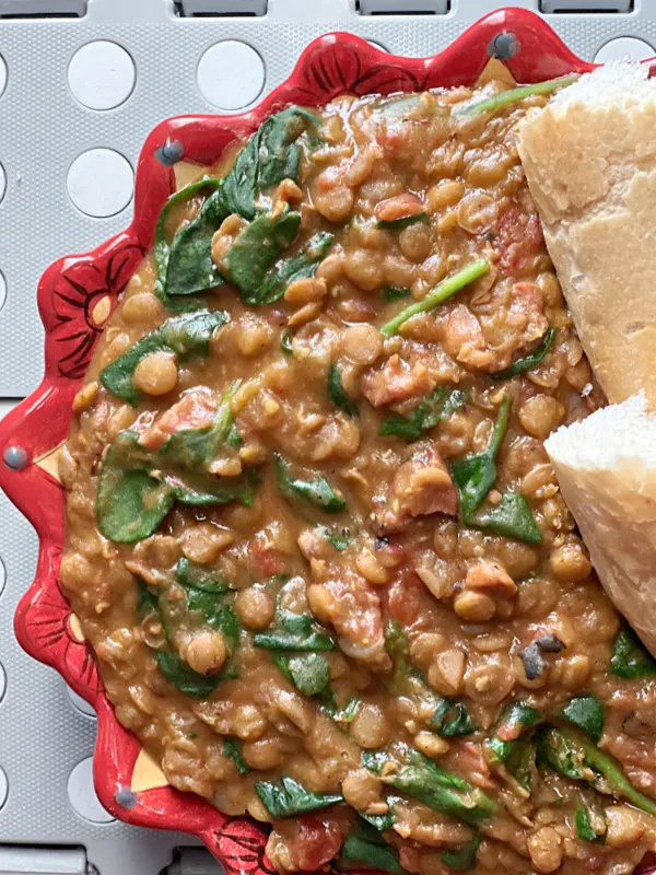 bowl of lentil stew with spinach