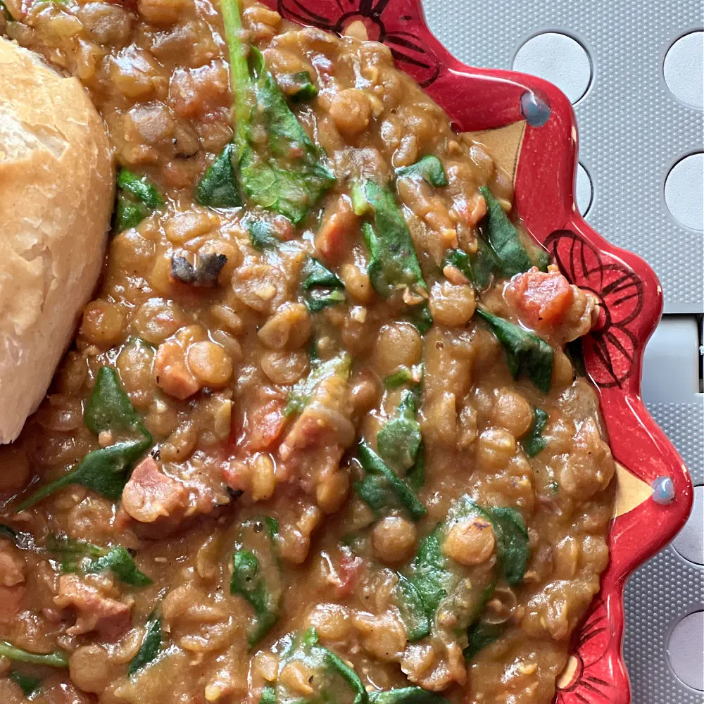 bowl of lentil stew with ham and spinach