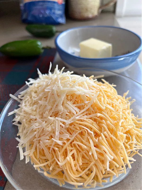 shredded cheddar and parmesan cheeses in a bowl