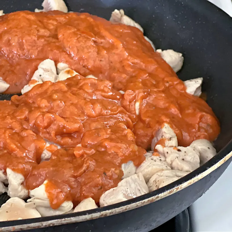 add sauce to the pan with the chicken