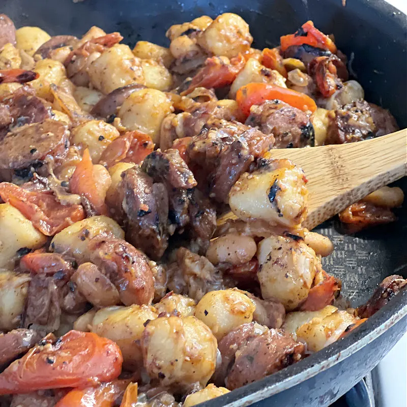 melted parmesan on gnocchi and sausage and tomatoes