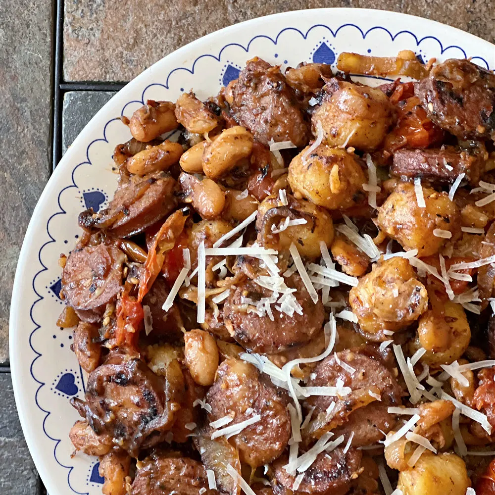 plate of gnocchi with sausage and beans