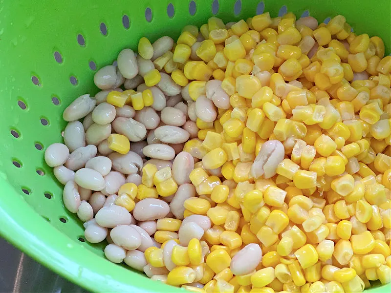 white beans and corn in a colander