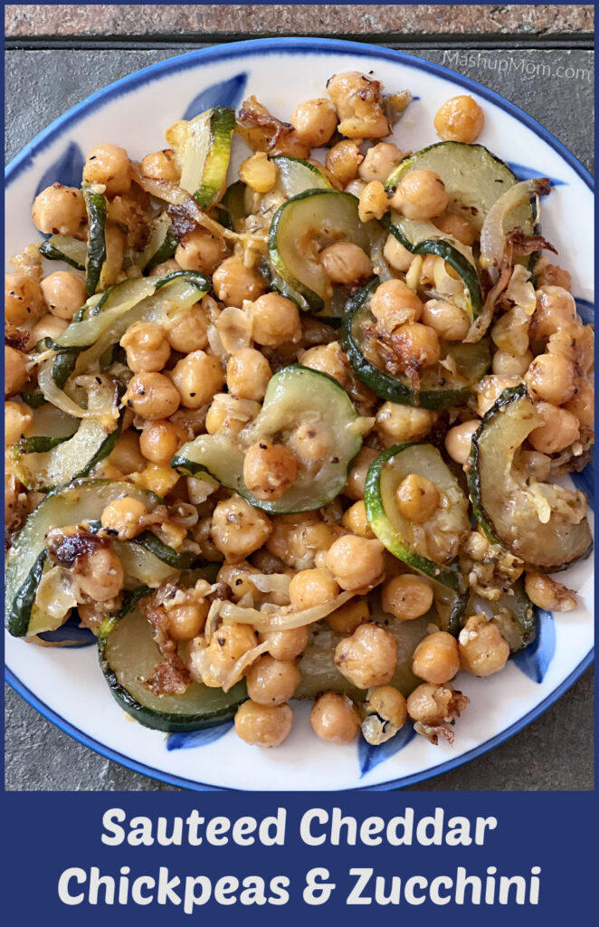 sauteed cheddar chickpeas and zucchini on a blue and white plate