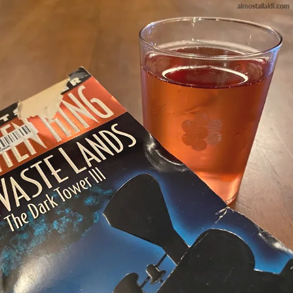 stephen king book with a glass of bubbly rose