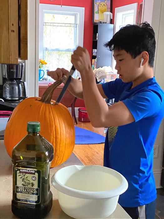 middle school guy cutting a pumpkin